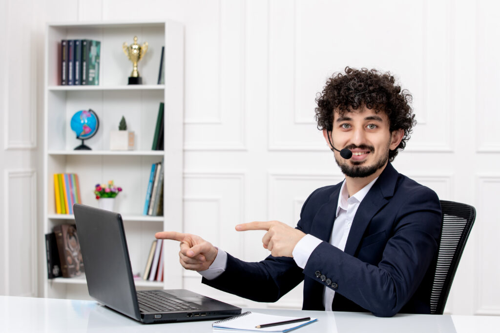 customer-service-handsome-curly-man-office-suit-with-computer-headset-smiling